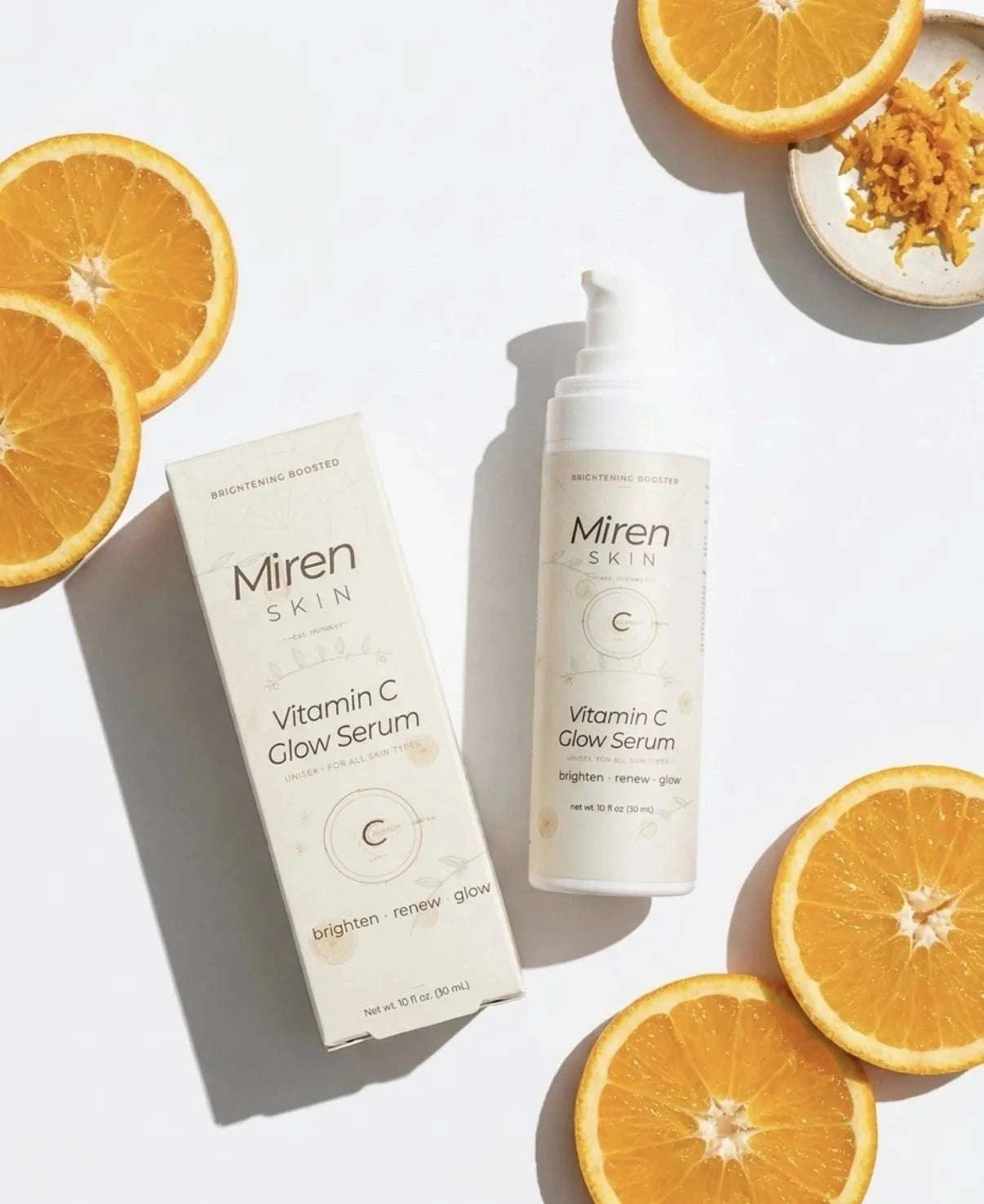 Miren Skin Vitamin C Glow Serum with packaging on a white background with oranges.