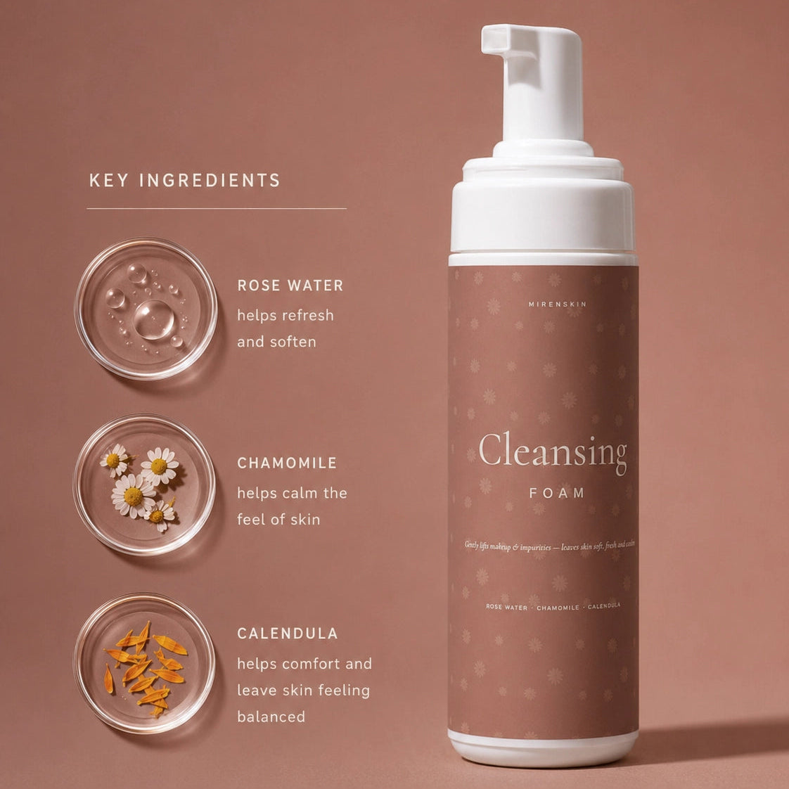 A bottle of cleansing foam with a white pump and a dusty rose label stands on a matching dusty rose background. To the left, text reads 'KEY INGREDIENTS' with three circular ingredient insets labeled rose water, chamomile, and calendula, plus descriptions of their skin benefits.